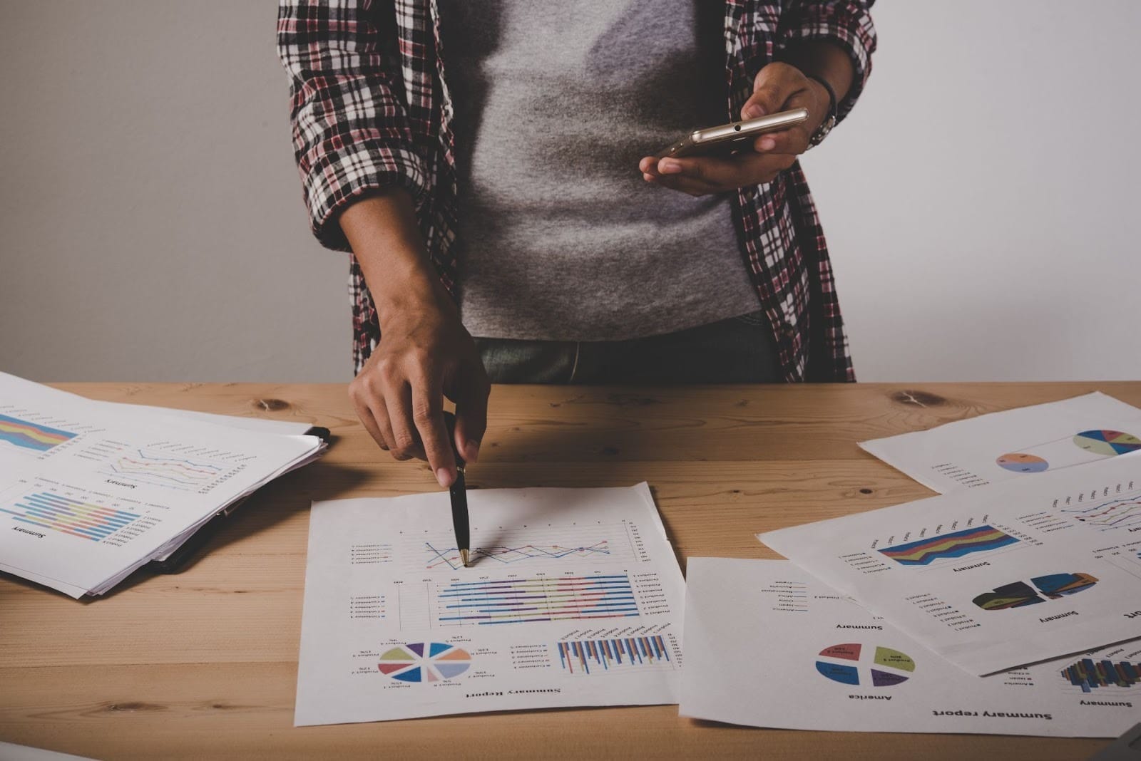 Person reviewing financial charts and performance reports - Freepik