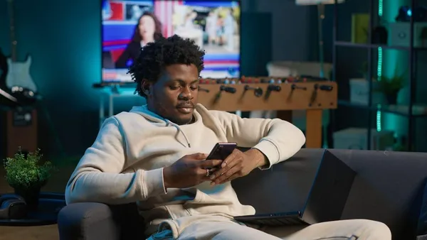 https://www.freepik.com/free-photo/relaxed-african-american-freelancer-smiling-while-browsing-his-smartphone_418229832.htm